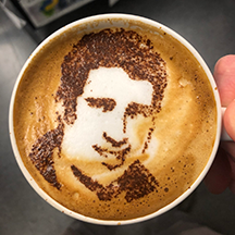 coffee cup with Andrew Minor's portrait in chocolate on top of coffee